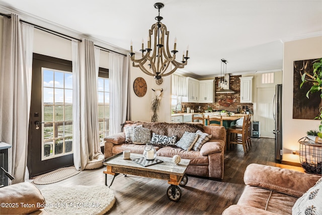 26 Merrimac Trl, Boulder, WY 82923 - living area with a chandelier, dark wood-style flooring, and ornamental molding