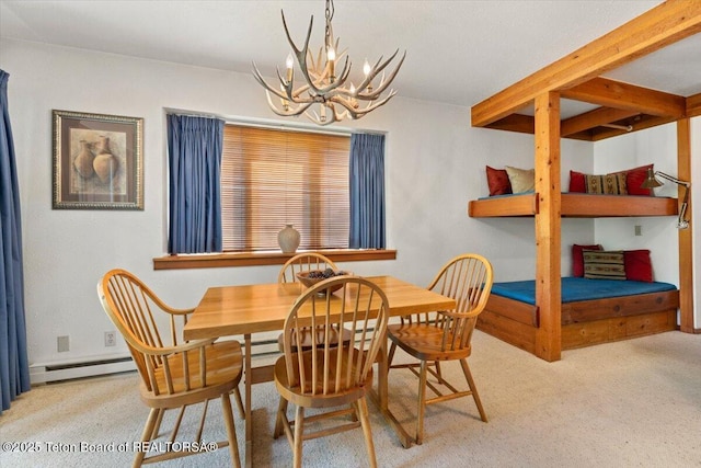 3705 N Teton Dr # 914, Wilson, WY 83014 - carpeted dining room with a baseboard heating unit and a chandelier