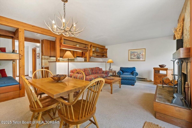 3705 N Teton Dr # 914, Wilson, WY 83014 - dining area with a chandelier, carpet, and baseboard heating