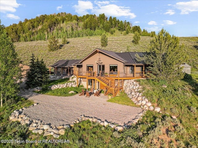 20 Trail Ride Ln, Cora, WY 82925 - rear view of property featuring a deck, a metal roof, stairway, and a standing seam roof