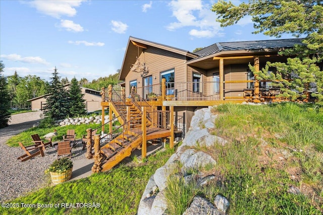 20 Trail Ride Ln, Cora, WY 82925 - view of home's exterior featuring stairway, a wooden deck, an outdoor fire pit, and a metal roof
