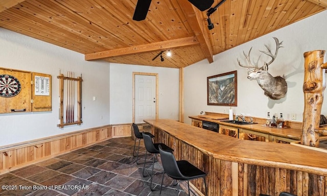 20 Trail Ride Ln, Cora, WY 82925 - indoor bar with a wooden ceiling with exposed beams, dark stone finish floors, a wainscoted wall, black dishwasher, and wooden walls