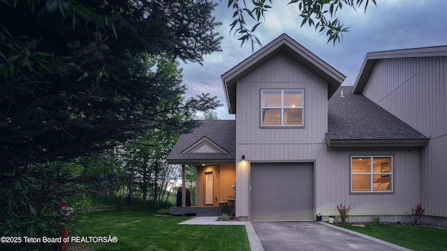 112 Aspen Meadows Rd Unit 36, Driggs, ID 83422 - view of front of house with a shingled roof, asphalt driveway, a front lawn, and a garage