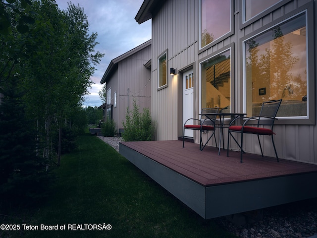 112 Aspen Meadows Rd Unit 36, Driggs, ID 83422 - deck at dusk with a lawn and outdoor dining space