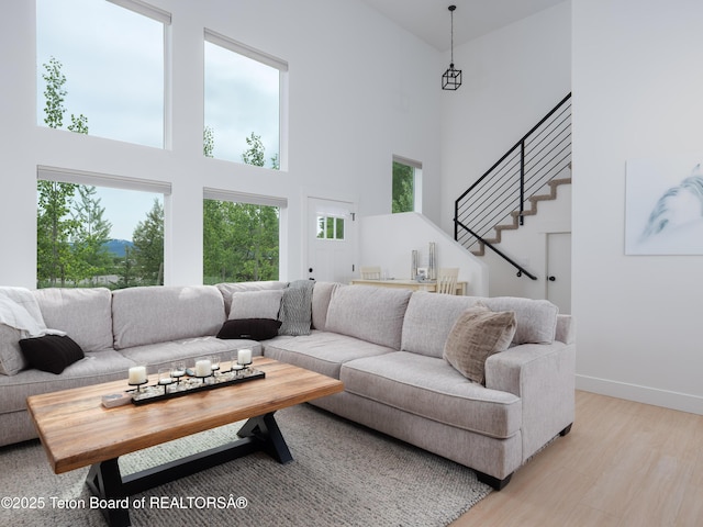 112 Aspen Meadows Rd Unit 36, Driggs, ID 83422 - living area with a towering ceiling, light wood-style floors, and stairway