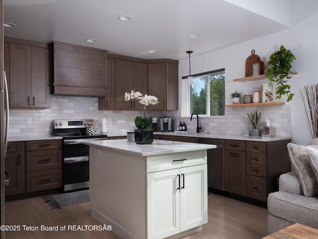 112 Aspen Meadows Rd Unit 36, Driggs, ID 83422 - kitchen with appliances with stainless steel finishes, extractor fan, wood finished floors, tasteful backsplash, and recessed lighting