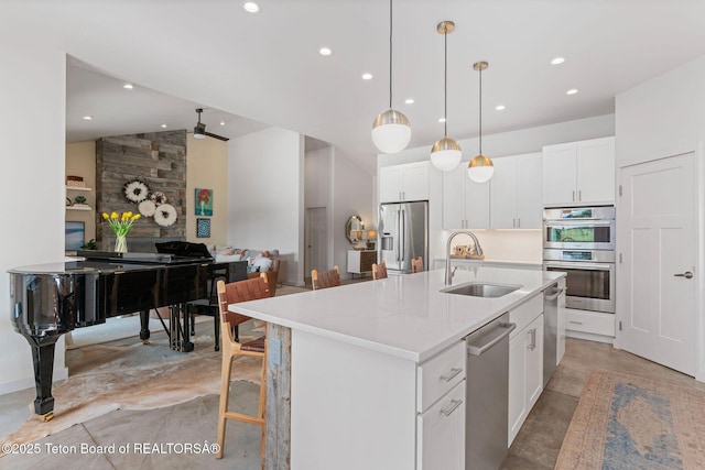 4345 Melody Ranch Dr, Jackson, WY 83001 - kitchen featuring appliances with stainless steel finishes, finished concrete flooring, recessed lighting, a center island with sink, and white cabinetry