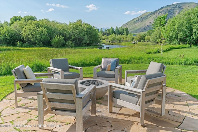 4345 Melody Ranch Dr, Jackson, WY 83001 - view of patio with a fire pit and a water and mountain view