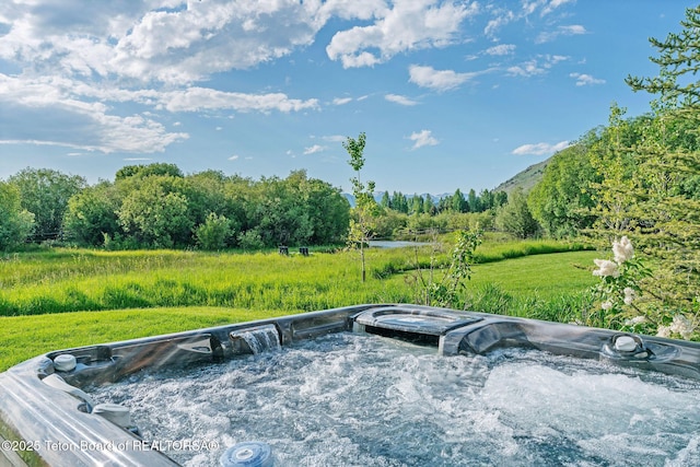 4345 Melody Ranch Dr, Jackson, WY 83001 - deck with a hot tub and a wooded view