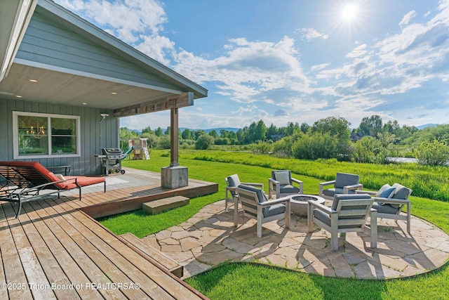 4345 Melody Ranch Dr, Jackson, WY 83001 - view of grassy yard featuring an outdoor fire pit, a patio area, and a deck