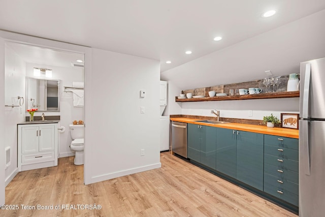 4345 Melody Ranch Dr, Jackson, WY 83001 - indoor bar with appliances with stainless steel finishes, light wood-type flooring, recessed lighting, and lofted ceiling