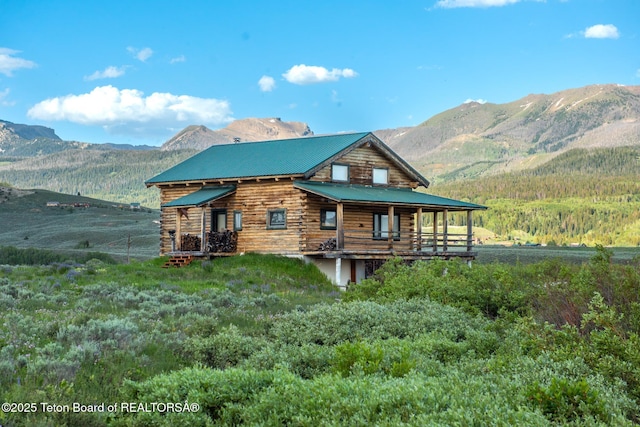15 S Rainbow Dr, Cora, WY 82925 - rear view of house featuring log exterior, a mountain view, and a metal roof