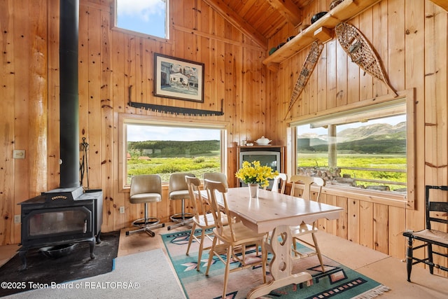 15 S Rainbow Dr, Cora, WY 82925 - dining space with high vaulted ceiling, a wood stove, wooden walls, and wood ceiling