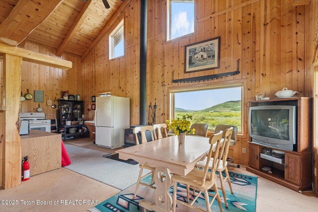 15 S Rainbow Dr, Cora, WY 82925 - dining room with high vaulted ceiling, wooden walls, a wooden ceiling with exposed beams, and carpet