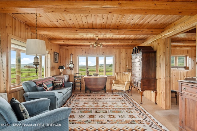 15 S Rainbow Dr, Cora, WY 82925 - living area featuring healthy amount of natural light, wood walls, a wood ceiling with exposed beams, light carpet, and a chandelier