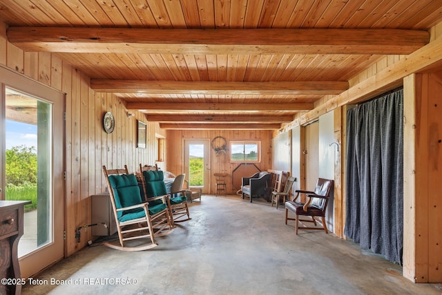 15 S Rainbow Dr, Cora, WY 82925 - living area featuring unfinished concrete floors, a wood ceiling with exposed beams, and wooden walls