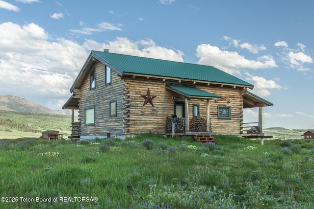 15 S Rainbow Dr, Cora, WY 82925 - view of front facade featuring log exterior, a metal roof, and a mountain view