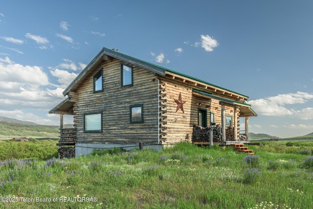 15 S Rainbow Dr, Cora, WY 82925 - view of home's exterior featuring log exterior and a porch