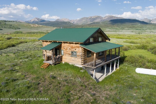 15 S Rainbow Dr, Cora, WY 82925 - back of property featuring log siding, a metal roof, and a deck with mountain view