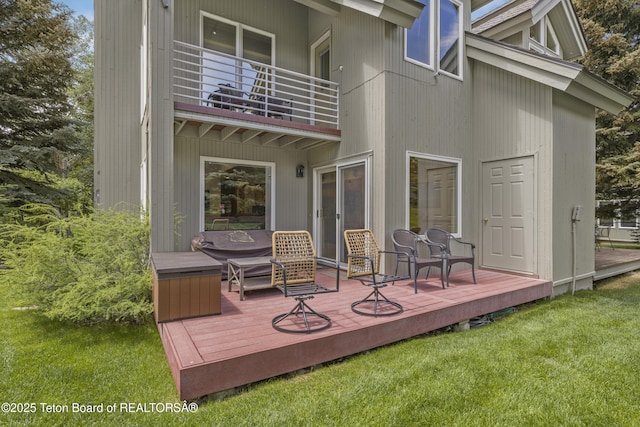 536 Shadow Brook Ln, Driggs, ID 83422 - rear view of house featuring a balcony, a lawn, a hot tub, and a wooden deck