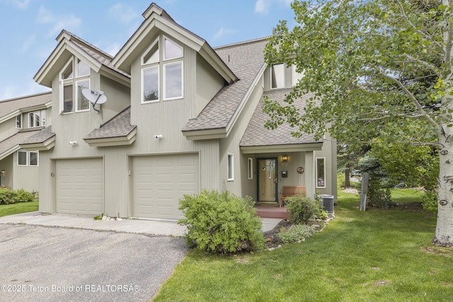 536 Shadow Brook Ln, Driggs, ID 83422 - view of property featuring roof with shingles, asphalt driveway, an attached garage, and a front yard