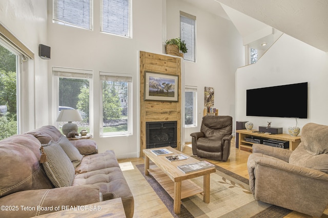 536 Shadow Brook Ln, Driggs, ID 83422 - living area featuring a towering ceiling, a fireplace, and light wood-style floors