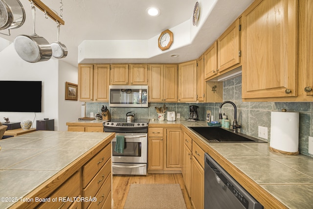 536 Shadow Brook Ln, Driggs, ID 83422 - kitchen with stainless steel appliances, tile counters, light wood-style floors, backsplash, and recessed lighting