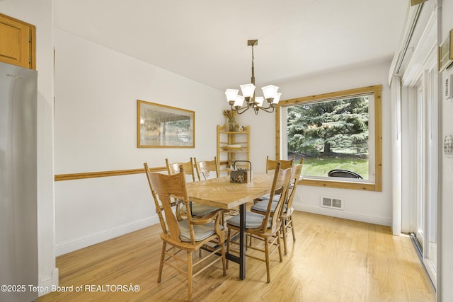 536 Shadow Brook Ln, Driggs, ID 83422 - dining space with light wood-style flooring and a chandelier