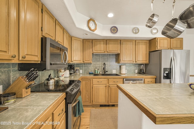 536 Shadow Brook Ln, Driggs, ID 83422 - kitchen featuring stainless steel appliances, tile countertops, tasteful backsplash, light wood-style floors, and recessed lighting
