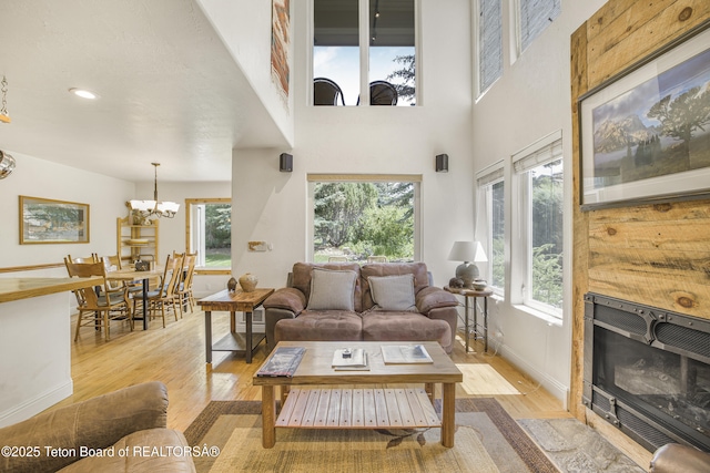 536 Shadow Brook Ln, Driggs, ID 83422 - living room featuring light wood-type flooring, a chandelier, a high ceiling, and recessed lighting