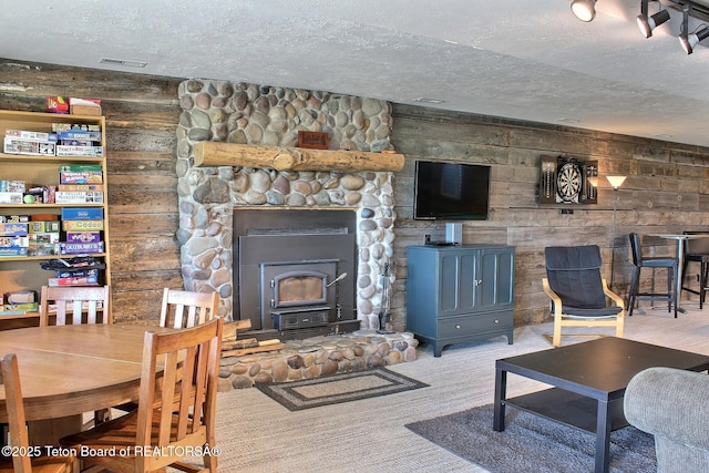 3525 W 13000 N, Felt, ID 83424 - living area with a textured ceiling, a wood stove, and carpet floors