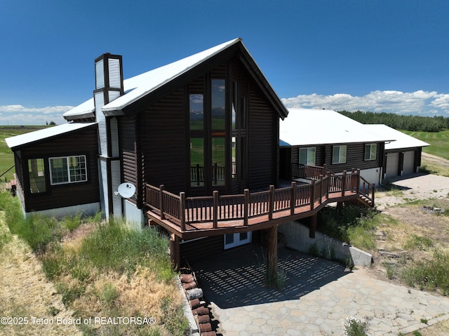 3525 W 13000 N, Felt, ID 83424 - rear view of house featuring a wooden deck, a chimney, a garage, and a patio area