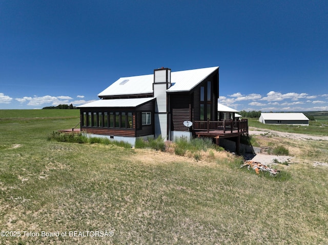 3525 W 13000 N, Felt, ID 83424 - view of side of home with a lawn, a deck, a metal roof, and a sunroom