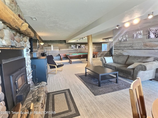 3525 W 13000 N, Felt, ID 83424 - carpeted living area with wooden walls, pool table, a wood stove, and a textured ceiling