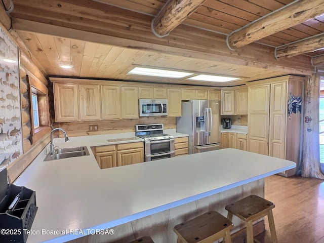 3525 W 13000 N, Felt, ID 83424 - kitchen featuring appliances with stainless steel finishes, a wooden ceiling with exposed beams, a peninsula, a kitchen breakfast bar, and light wood-style flooring