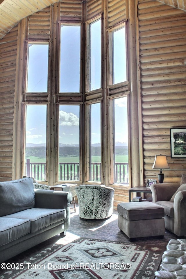 3525 W 13000 N, Felt, ID 83424 - living area with log walls, high vaulted ceiling, healthy amount of natural light, and a water view