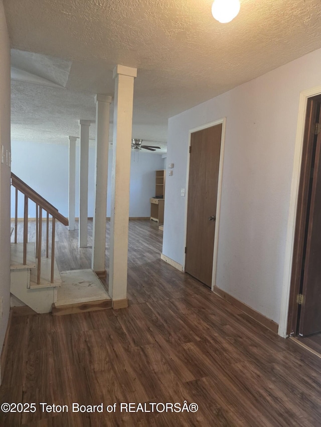 321 Smith Ave, Big Piney, WY 83113 - stairs with wood finished floors, ceiling fan, a textured ceiling, and ornate columns