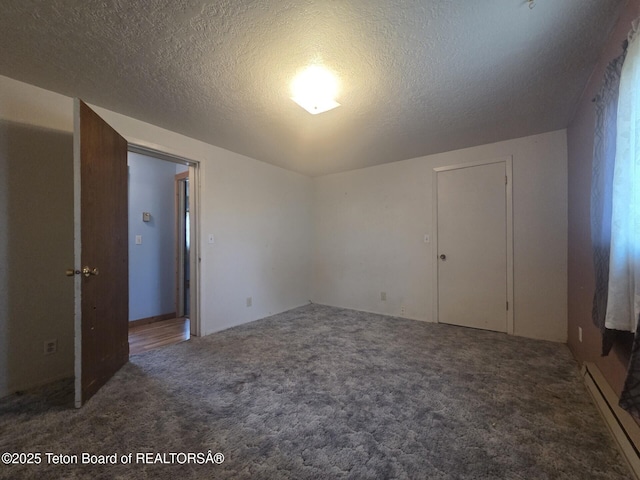 321 Smith Ave, Big Piney, WY 83113 - unfurnished bedroom featuring carpet, a baseboard radiator, and a textured ceiling