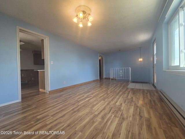 321 Smith Ave, Big Piney, WY 83113 - unfurnished room featuring baseboard heating and wood finished floors