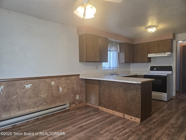 321 Smith Ave, Big Piney, WY 83113 - kitchen with electric range, under cabinet range hood, a baseboard radiator, a peninsula, and dark wood-type flooring