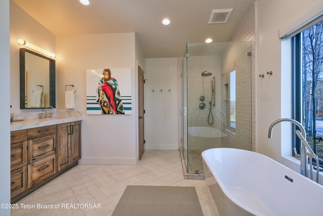 9632 Little Pine Ln, Victor, ID 83455 - bathroom with vanity, a soaking tub, a shower stall, and recessed lighting