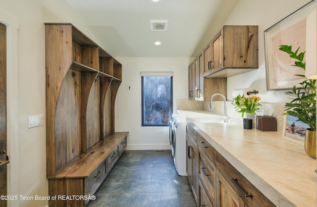 9632 Little Pine Ln, Victor, ID 83455 - washroom with independent washer and dryer, dark stone finish floors, cabinet space, and recessed lighting