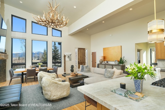 9632 Little Pine Ln, Victor, ID 83455 - living area featuring a chandelier, light wood-style floors, a high ceiling, and recessed lighting