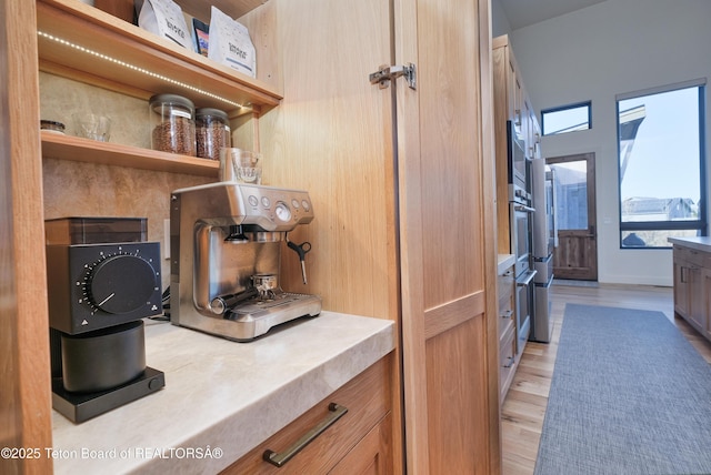 9632 Little Pine Ln, Victor, ID 83455 - kitchen featuring open shelves, light wood finished floors, light countertops, and stainless steel microwave