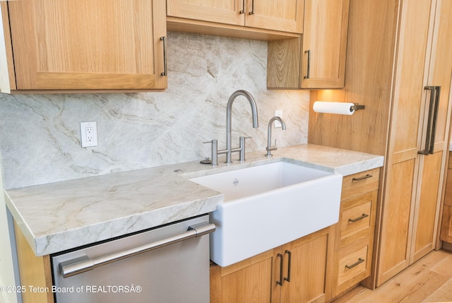 9632 Little Pine Ln, Victor, ID 83455 - kitchen featuring stainless steel dishwasher, tasteful backsplash, light stone countertops, and light wood-style flooring