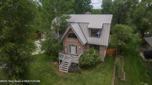 939 W Stuart St, Pinedale, WY 82941 - view of front facade with a chimney, a metal roof, stairway, a standing seam roof, and a deck