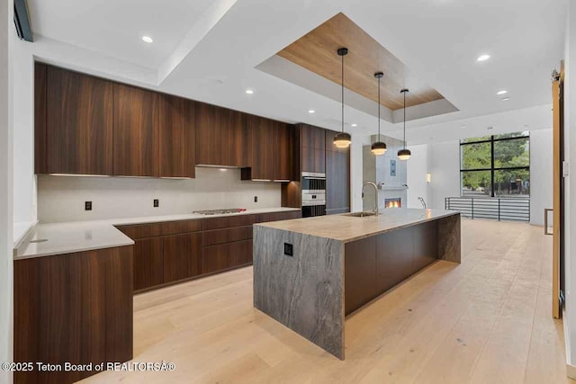 165 N Glenwood St # 30, Jackson, WY 83001 - kitchen featuring a raised ceiling, modern cabinets, gas stovetop, light countertops, and recessed lighting