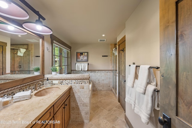 5862 N Coneflower Dr Unit 17, Jackson, WY 83001 - full bath with vanity, a stall shower, tile walls, a garden tub, and tile patterned flooring