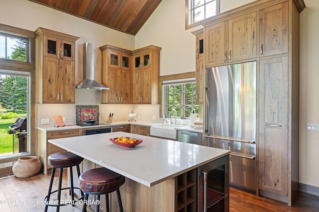5862 N Coneflower Dr Unit 17, Jackson, WY 83001 - kitchen featuring stainless steel appliances, wall chimney exhaust hood, dark wood-style flooring, wine cooler, and a center island