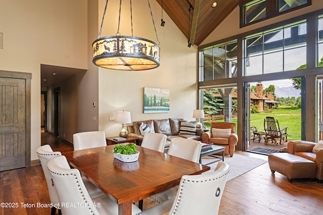 5862 N Coneflower Dr Unit 17, Jackson, WY 83001 - dining space featuring high vaulted ceiling, healthy amount of natural light, and hardwood / wood-style floors